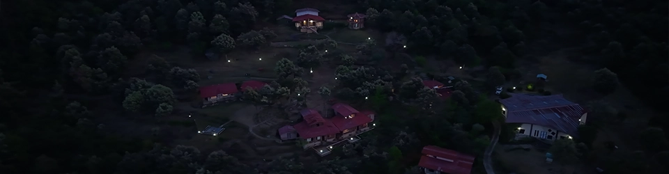 An evening bonfire glowing against dark hills